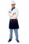 Confident Young Cook Posing In Uniform Stock Photo