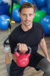 Happy Man Doing Stretching Exercises In A Health Club Stock Photo