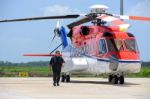 Offshore Helicopter Pilot Is Walking And Smiling Beside Of S92 H Stock Photo