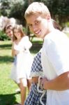 Happy Friends Pulling A Rope Against Each Other Stock Photo