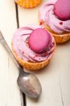 Pink Berry Cream Cupcake With Macaroon On Top Stock Photo