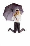 Front View Of Jumping Woman Holding An Umbrella Stock Photo