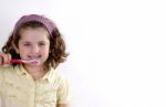 Female Child Brushing Her Teeth Stock Photo