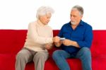 An Old Couple Holding Money Stock Photo