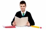 Schoolboy Holding book Stock Photo