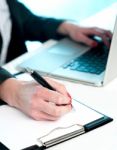 Closeup Of Woman Copying Data From Laptop Stock Photo