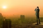 Business Man And Binocular Spying Acting Standing On Top Of Offi Stock Photo