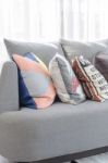 Colorful Pillows On Modern Grey Sofa Stock Photo