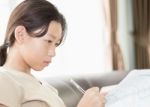 Asian Girl Writing On Lesson Book Stock Photo