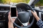 Young Female Driver Using Touch Screen Smartphone And Hand Holdi Stock Photo