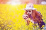 Woman Taking Photos At A Rapeseed Flowers Stock Photo