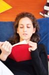 Woman Reading Book At Home Stock Photo