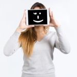 Young Woman Cover Her Face With Digital Tablet. Isolated On Whit Stock Photo