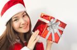 Santa Claus Hat With Red Christmas Gift Box Stock Photo