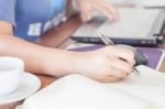 Woman Writing On Notebook Stock Photo