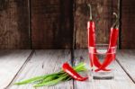 Red Hot Chili Peppers And Green Onions In Glass Of Water Stock Photo