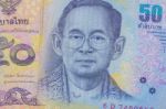 Close Up Of Thailand Currency, Thai Baht With The Images Of Thailand King. Denomination Of 50 Bahts Stock Photo