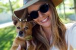 Beautiful Young Woman Looking At Camera With Her Dog Stock Photo