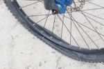 Bicycle Wheel With Flat Tyre On The Concrete Road Stock Photo