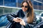 Beautiful Young Woman Using Her Mobile Phone In The Car Stock Photo