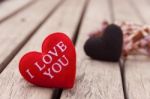 Red Heart On Wood Floor With Black Heart On Background Stock Photo