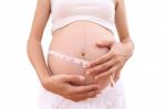 Face Of Pregnancy And Tapeline Abdomen On White Background Stock Photo