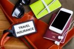 Travel Insurance Tag With Tourist Accessories Stock Photo