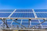 Metal Frames With Rows Of Blue Solar Collectors And Sky Stock Photo