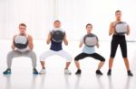 Diverse Group Of People Exercising With Pilates In Gym Stock Photo