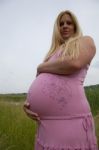 Pregnant Woman Relaxing Outdoors Stock Photo