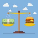 Money And Burger Balance On The Scale Stock Photo