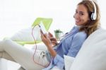 Beautiful Young Woman Listening To Music With Digital Tablet At Stock Photo