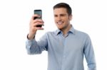 Young Man Browsing In Mobile Phone Stock Photo