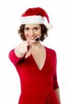 Young Female Santa Pointing Towards You Stock Photo