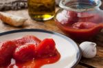 Canned Tomatoes In A Glass Jar Stock Photo