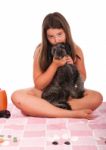 Girl In Swimsuit At The Beach Kissing Her Dog Stock Photo