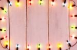 Christmas Light Decorations On Wood Texture Stock Photo