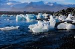 Ices On The Beach With Snow Covered Mountain Background Stock Photo