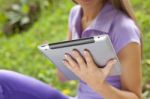 Beautiful Woman With Tablet Computer In Park Stock Photo