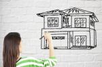 Lady Drawing House On Brick Wall Stock Photo