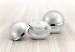 Silver Sphere Cosmetic Jar On Wood Background Stock Photo