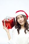 Beautiful Asian Santa Woman Showing Gift Stock Photo