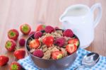 Bran Flakes With Fresh Raspberries And Strawberries And Pitcher Stock Photo