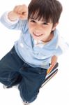 Top View Of Cute Kid Sitting On Books Stock Photo