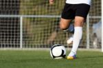 Shoot Of Football Player On The Outdoors Field Stock Photo