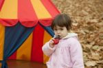 Little Girl Eats  In The Park Stock Photo