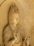 Kuan Yin Image Of Buddha , Wood Carving In A Thai Temple Stock Photo