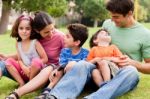 Happy Family Enjoying Summer Day In The Park Stock Photo