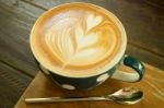 Latte Art Coffee Cup On Wood Table Stock Photo