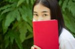 Thai Adult Student University Beautiful Girl Reading Red Book Stock Photo